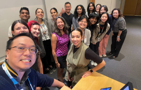Selfie of group of researchers and students all standing and smiling.