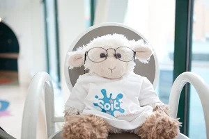 Placeholder image of a lamb plushie wearing glasses and a Spit for Science t-shirt