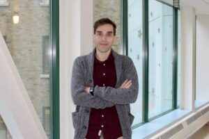 Placeholder image of a lamb plushie wearing glasses and a Spit for Science t-shirt