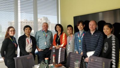 The Friedberg lab standing together in a meeting room