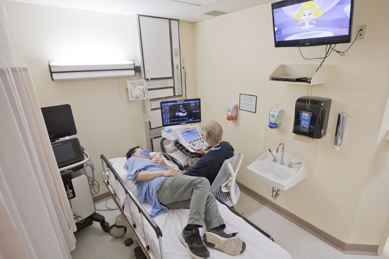 The cardiac ultrasound houses the ultrasound machine, hospital bed and television.