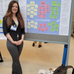 Yanara Marks standing in front of her poster