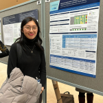 Lucy Zhao standing in front of her poster