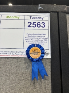 A close-up picture of the President's Award, given to Olivia Novosel in recognition of a top poster at the American College of Rheumatology (ACR) confernece, 2025