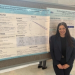 Sabrina standing in front of her poster