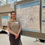 Yanara standing in front of her poster