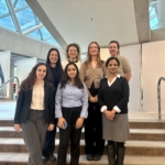7 People standing near stairs & posing for a picture