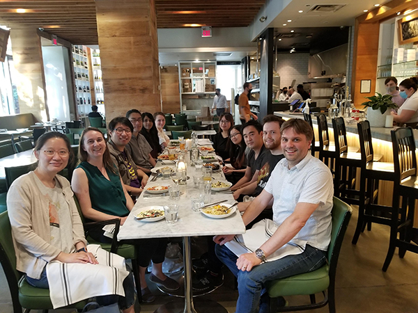 Eleven members of Li lab seated around a table for a restaurant meal.