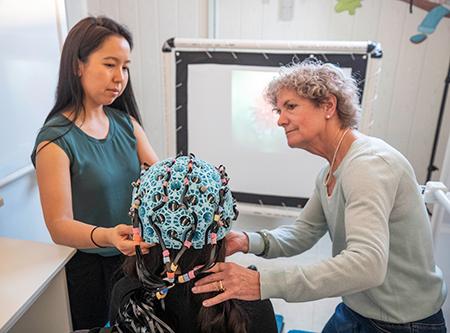 Dr. Julie Sato (left) and Dr. Margot Taylor (right) helping a participant get ready for an OPM scan Dr. Julie Sato (left) and Dr. Margot Taylor (right) helping a participant get ready for an OPM scan