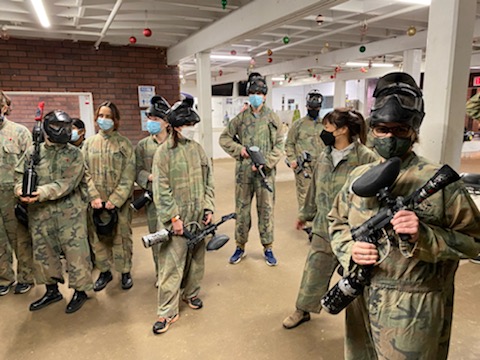 Group photo of lab members waiting for game to start at paintball