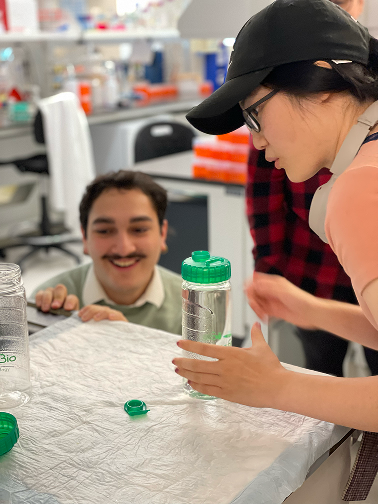 Photo of lab member observing another during a Lab Olympics game