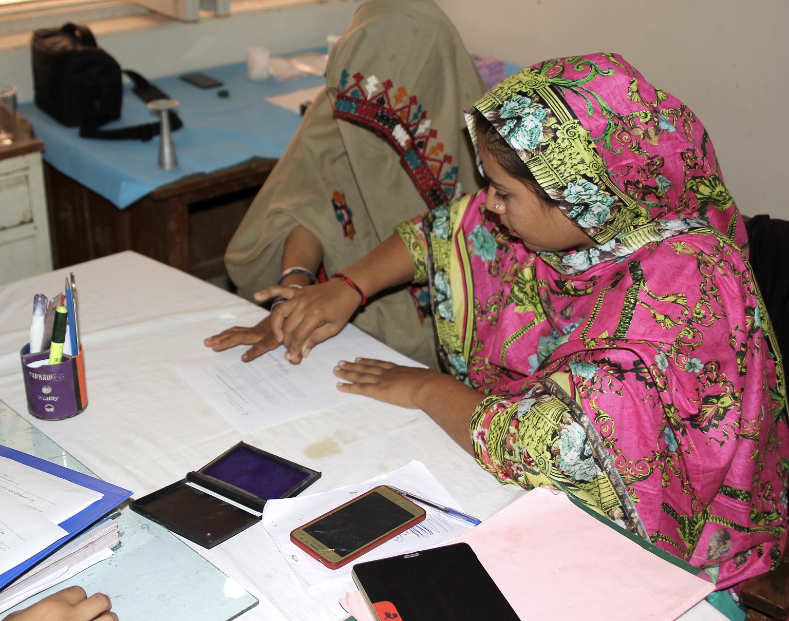 A Lady Health Visitor collecting informed consent from a participant in the study