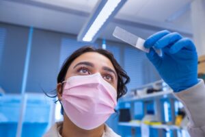 A woman looking up at a histology slide