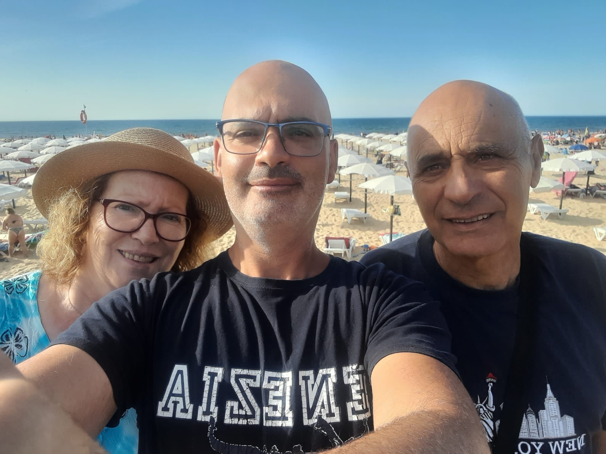 A selfie of Sergio Simoes with his parents on the beach.