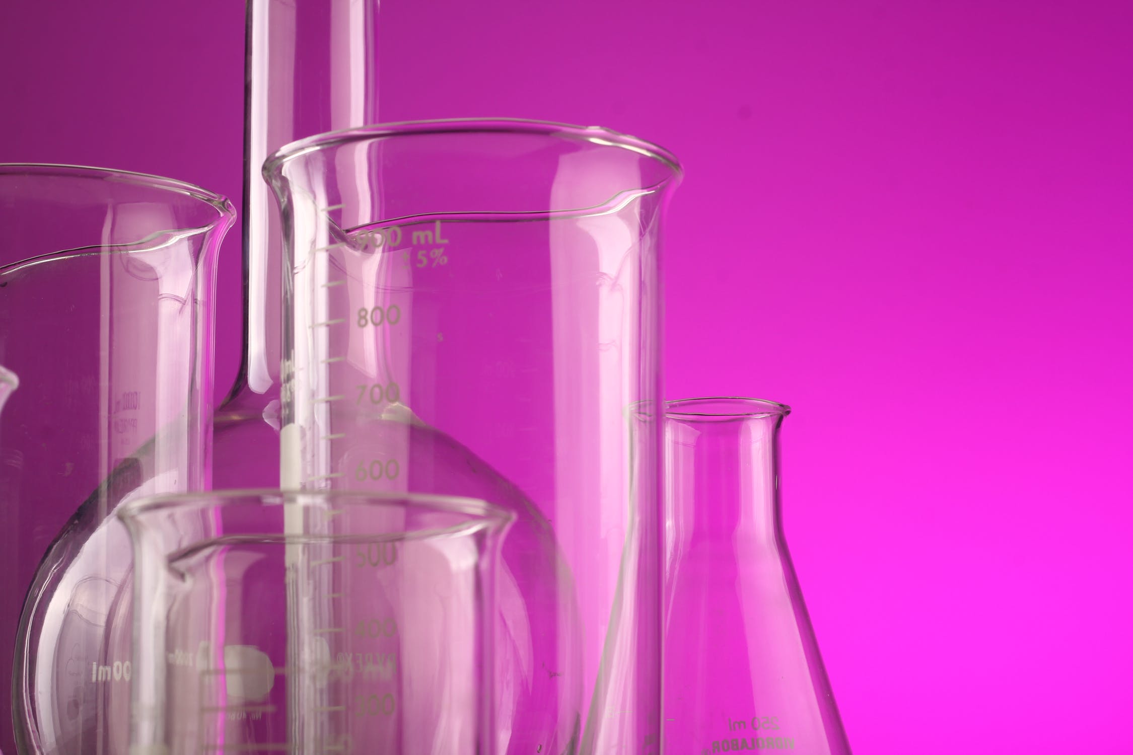 beakers with pink background