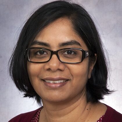 Headshot of Dr. Padmaja Subbarao smiling with dark-rimmed glasses