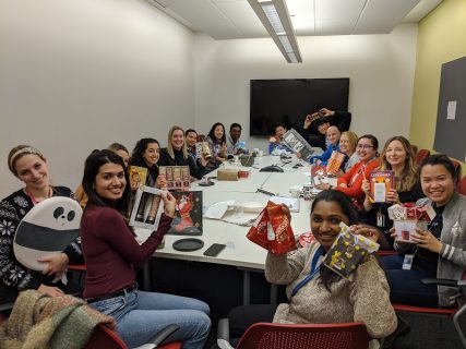16 members of the Tabori Laboratory showing their gifts, following a white elephant gift exchange in December 2019