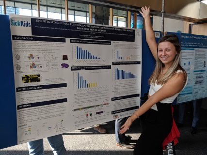 Darya Semenova, a former member of the Tabori Lab, showing her poster presentation called "investigating human tumorgenesis driving mutations in replication repair deficiency mouse models"