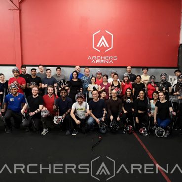 Lab members wearing Archery equipment during a team building event