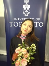 Anita Yin holding flowers at University of Toronto graduation